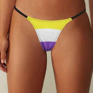 May include: A black string bikini bottom with a yellow, white, and purple striped pattern.