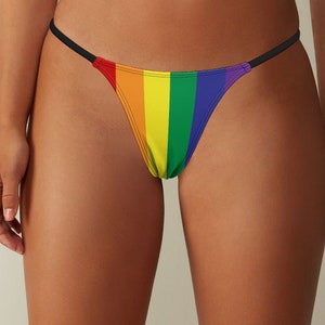 May include: Rainbow striped bikini bottom with thin black straps.