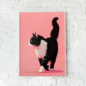 May include: A framed art print featuring a stylized illustration of a black and white cat on a pink background. The cat is depicted walking with its tail up. The artwork is displayed against a white brick wall.