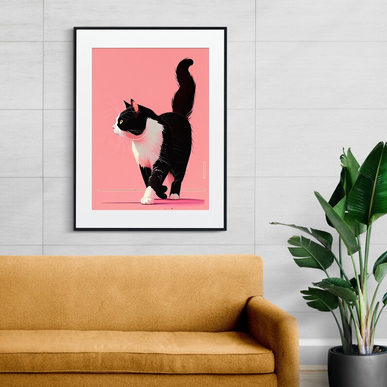 May include: A framed art print featuring a stylized black and white cat walking across a pink background. The cat has a white chest and paws, with a black tail and ears. The artwork is displayed on a white wall above a mustard-colored sofa.