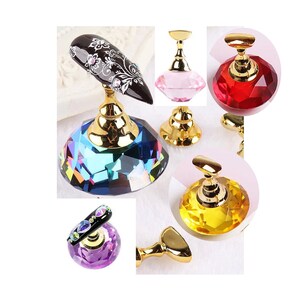 May include: Set of five nail art display stands with gold bases and crystal-shaped tops in various colors, including pink, red, yellow, purple, and blue.