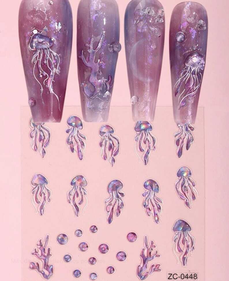 May include: A sheet of iridescent nail art stickers featuring jellyfish, coral, and bubbles. The stickers are on a pink background and have a holographic finish.