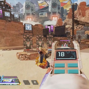 May include: A video game screen showing a first-person perspective of a player aiming a weapon at a target range. The player is using a pink and white weapon with a digital display that reads "18". The target range is in a desert environment with a large, futuristic structure in the background.