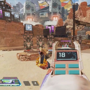May include: A first-person view of a video game, showing a player aiming a pink and white weapon at a target range. The weapon has a digital display that reads "18". The player is in a desert-like environment with targets in the distance.