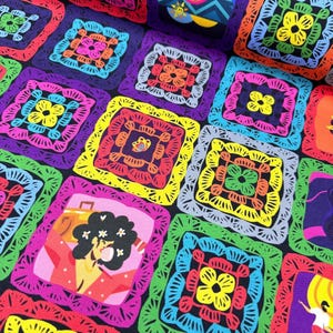 May include: A colorful fabric featuring a repeating pattern of square crochet designs. Each square has a central floral motif and is framed by a contrasting border. The squares are in various colors, including purple, green, yellow, and pink.