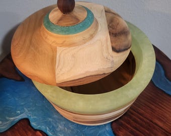 Teak candy dish with lid containing multiple shades of green resin.