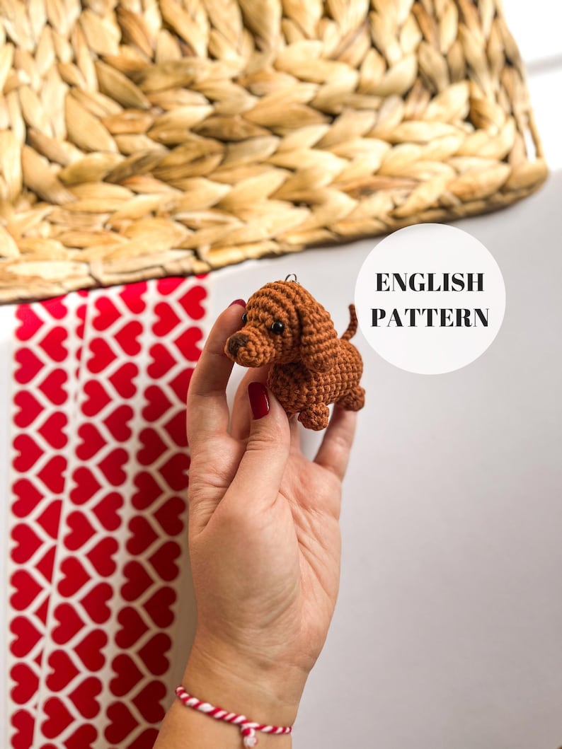 May include: Crochet pattern for a brown dachshund amigurumi toy. The pattern is written in English.