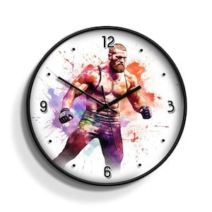 Könnte beinhalten: Eine schwarz-weiße Uhr mit einem Aquarellbild eines Mannes in Kampfstellung. Das Zifferblatt der Uhr hat schwarze Zahlen und Zeiger. Der Hintergrund ist weiß mit bunten Aquarellspritzer.
