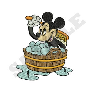 May include: Mickey Mouse is scrubbing a tub full of bubbles with a yellow and brown brush. He is wearing black shorts and has a big smile on his face.