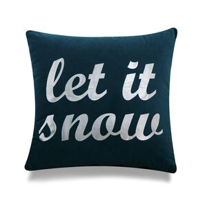 May include: Teal blue velvet throw pillow with silver lettering that reads "Let it snow".