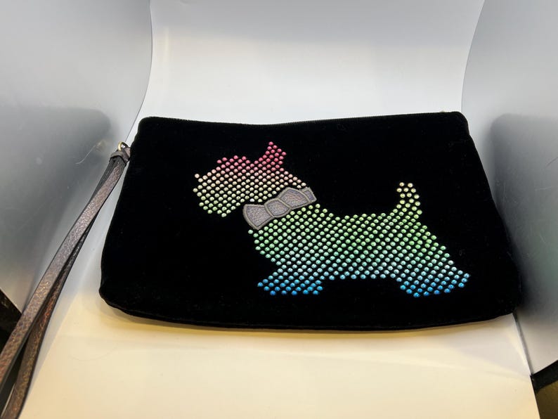 May include: Black velvet clutch with a rainbow-colored rhinestone dog design.