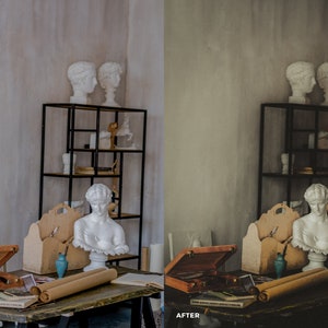 May include: A wooden table with a brown leather box, two rolled up pieces of parchment paper, and a blue vase. There are two white plaster busts on a black metal shelf in the background.
