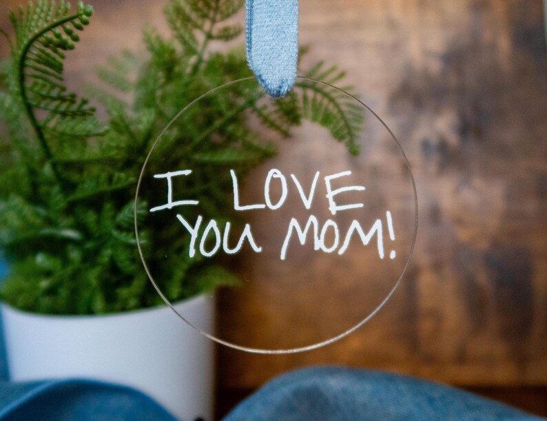 May include: A clear round bauble with the words "I love you Mom!" written in white marker.
