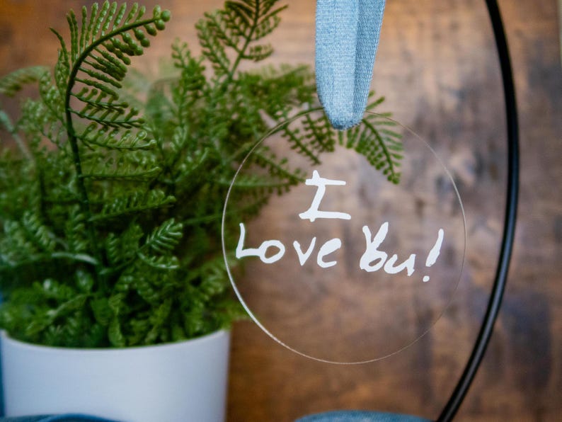 May include: A clear round bauble with the words "I love you!" written in white marker.
