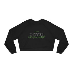 May include: Black cropped sweatshirt with the text "SLEEP BETTER With a Nurse Anesthetist" in green.