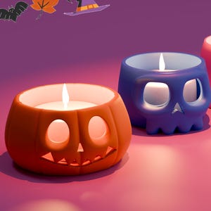 Può includere: Una collezione di candele a tema Halloween in varie forme, tra cui una zucca, un teschio, un fantasma e una mummia. Ogni candela è accesa, proiettando un bagliore caldo. Le candele sono arancioni, blu e rosa, con uno sfondo viola.