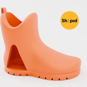 May include: A bright orange rubber boot with a cut-out design on the side. The boot has a textured sole and a rounded toe.