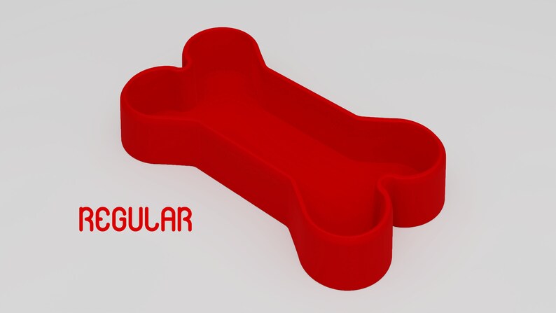 May include: Red bone-shaped silicone dog bowl. The bowl is designed to hold food or water for dogs. The text "REGULAR" is printed below the bowl.