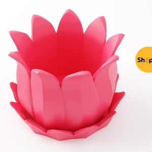 May include: A vibrant pink lotus flower-shaped container. The container has multiple petals and a wide opening. The design is modern and minimalist, suitable for home decor or as a decorative item.