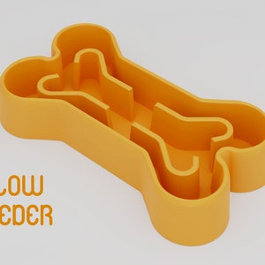 May include: Orange plastic bone-shaped slow feeder for dogs. The text "SLOW FEEDER" is printed below the bone.