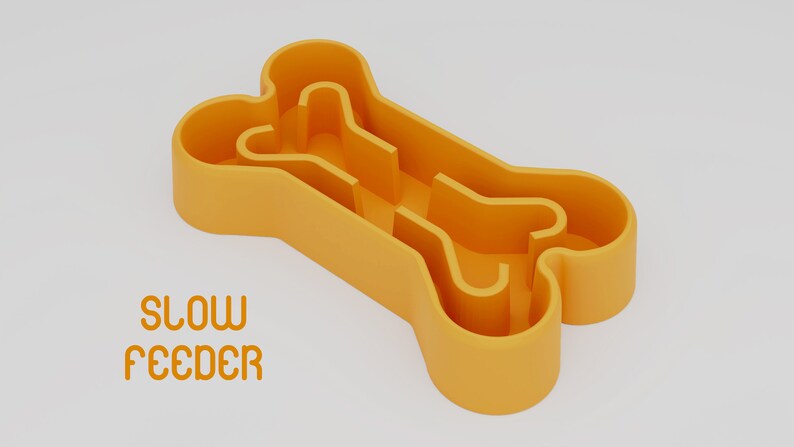May include: Orange plastic bone-shaped slow feeder for dogs. The text "SLOW FEEDER" is printed below the bone.