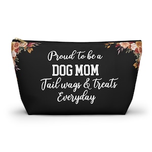 May include: Black zippered pouch with floral accents and the text "Proud to be a DOG MOM Tail wags & treats Everyday" in white script. The pouch is designed for dog lovers.