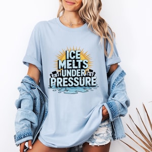 May include: A light blue t-shirt with a graphic design of a melting ice cube with the text "ICE MELTS UNDER PRESSURE".