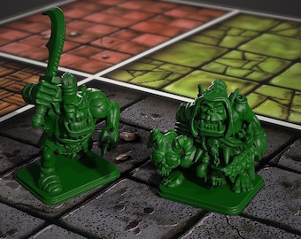 May include: Two green orc figurines on a game board. One orc holds a curved sword, the other is hunched over a horned creature. The game board has a stone tile pattern and red and green squares.