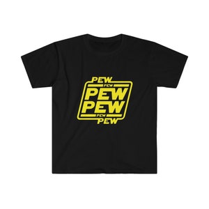May include: Black t-shirt with a yellow graphic that reads "PEW PEW PEW" in a stylized font. The design is enclosed in a yellow rectangular border. The shirt is made of a soft, comfortable material.