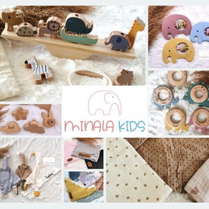 May include: A collection of wooden toys for babies and toddlers, including a seesaw with animal figures, a set of teethers, and a set of stacking rings. The toys are all made of natural wood and have a light, natural finish. The toys are arranged on a white background with a logo for the brand "Minala Kids".