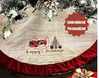 May include: Cream-colored Christmas tree skirt with a red border. The skirt features an embroidered fire truck, Christmas tree, and the words "Happy Holidays". The design is personalized.