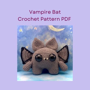 May include: A crocheted gray vampire bat with large black eyes, small white fangs, and black-edged wings. The text "Vampire Bat Crochet Pattern PDF" is displayed above the bat. The background features a blue sky with a moon and stars.