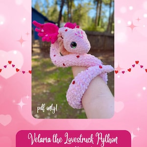 May include: A crochet pattern for a pink python amigurumi toy named Velaria the Lovestruck Python. The pattern is available as a PDF download and is by Pink Mew Crochet.