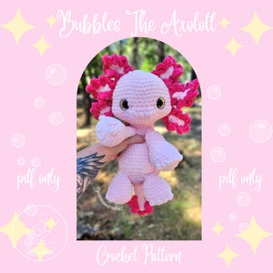 Puede incluir: Un patrón de crochet para un ajolote rosa con volantes rosas y blancos. El patrón se llama "Bubbles the Axolotl" y está disponible solo como descarga PDF.