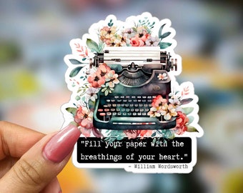May include: A vintage typewriter with floral accents and a quote by William Wordsworth: "Fill your paper with the breathings of your heart."