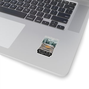 May include: A vintage typewriter with a snowy forest background. The text "worlds at my fingertips" is printed below the typewriter.