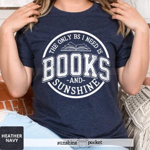May include: A navy blue t-shirt with a white circle graphic that says "The only BS I need is books -and- sunshine".