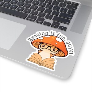 May include: A sticker with a cartoon mushroom wearing glasses and reading a book. The text on the sticker says "Reading is fun, guys!"