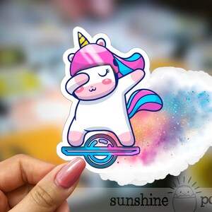 May include: A white unicorn with a pink and blue mane and tail is riding a hoverboard. The unicorn is wearing a pink helmet and has a yellow horn. The hoverboard is surrounded by a colorful galaxy-like background.