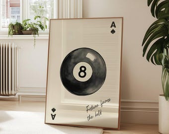May include: A framed art print featuring a black eight ball from a pool game, with the text "Future farms the hill". The print is displayed in a bright, airy living room setting with a white rug and wooden furniture.