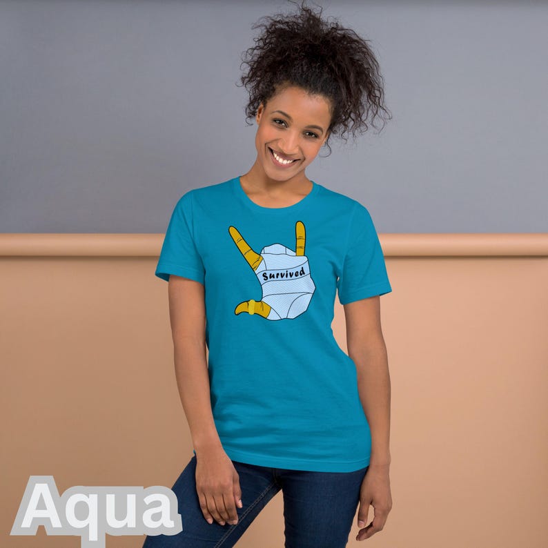 T-SHIRT - *Survived* Printed On A Combed and Ring Spun Cotton Unisex Short-Sleeved Top. FCK HMS. Aqua