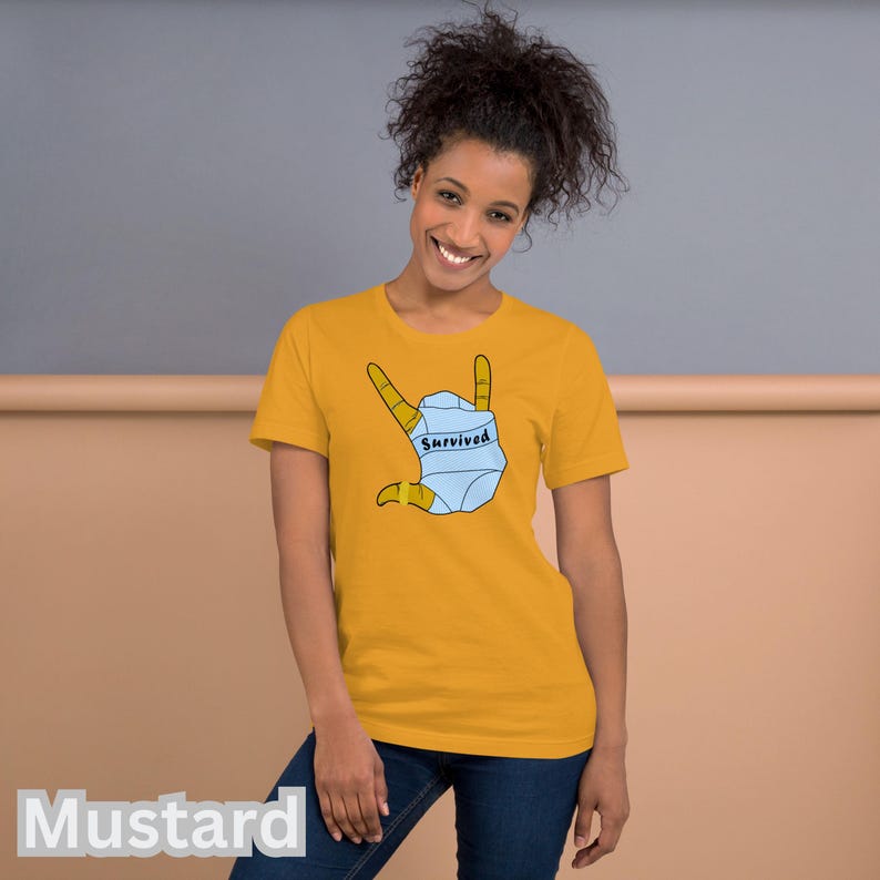 T-SHIRT - *Survived* Printed On A Combed and Ring Spun Cotton Unisex Short-Sleeved Top. FCK HMS. Mustard