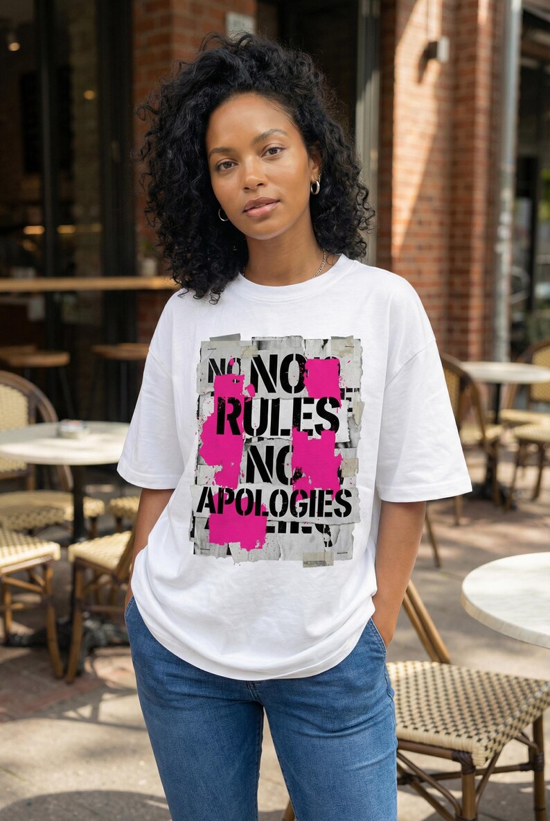 Women streetwear tee design “No Rules No Apologies” with distressed black typography and pink paint accents on white shirt