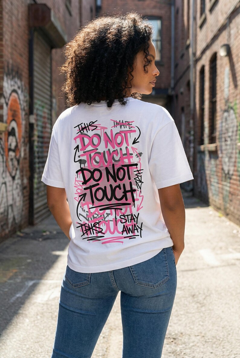 Women streetwear typography design “Noise Control” in distressed black letters with pink accent line on white graphic tee