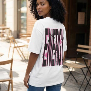 Women streetwear tee design “Energy” with distressed black typography and pink paint accents on white shirt