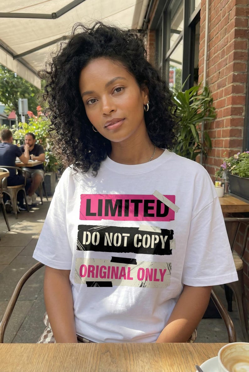 Women streetwear t-shirt design “Do Your Thing” with pink tape style shape and bold black lettering on white tee