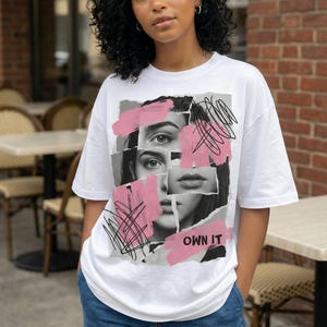 Edgy face collage graphic t-shirt design with pink brush strokes and “Own It” text for women’s streetwear style