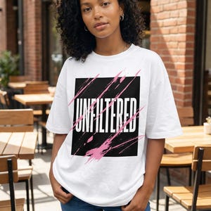 Abstract scribble streetwear graphic with black marker symbols and pink spray accents on women’s oversized t-shirt mockup