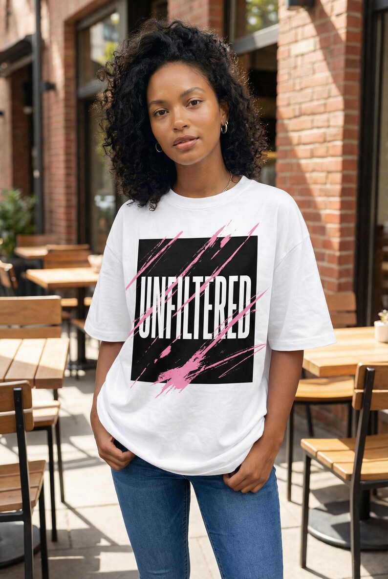 Abstract scribble streetwear graphic with black marker symbols and pink spray accents on women’s oversized t-shirt mockup