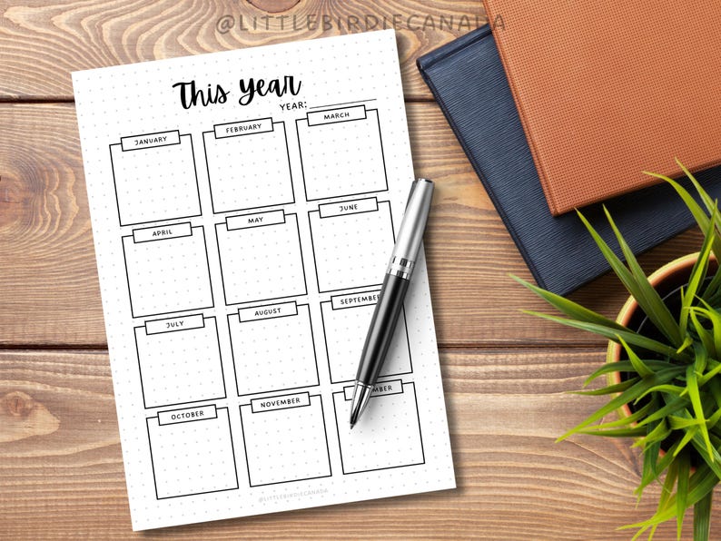 May include: A printable planner page with a grid layout for tracking monthly goals. The page is titled "This Year" and includes spaces for each month of the year, from January to December.